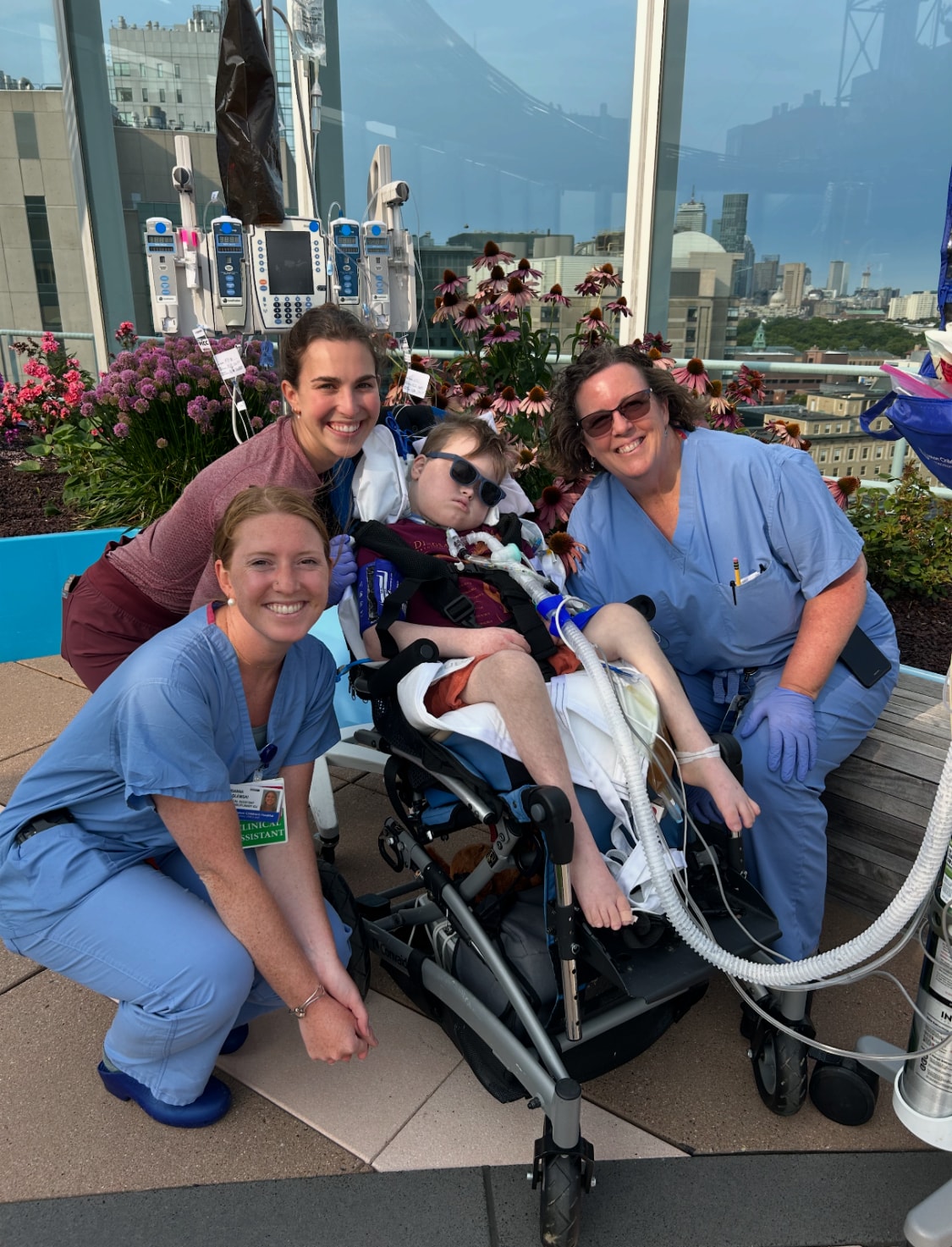 Oscar with nurses on the rooftop garden at Boston Children's